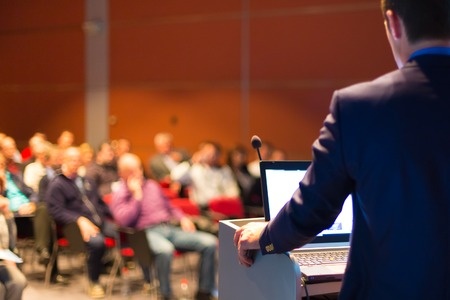 speaker at podium business speaker conferecne