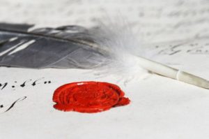 feather quill pen and wax seal